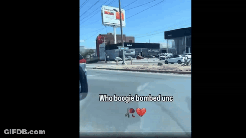 A Car Is Driving Down A Street With The Words Who Boogie Bombed Unc Written On The Windshield GIF
