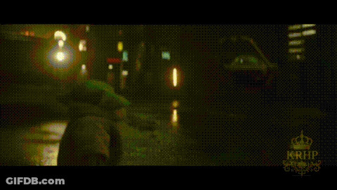 A Car Is Driving Down A Wet Street At Night With A Krhb Logo In The Corner GIF