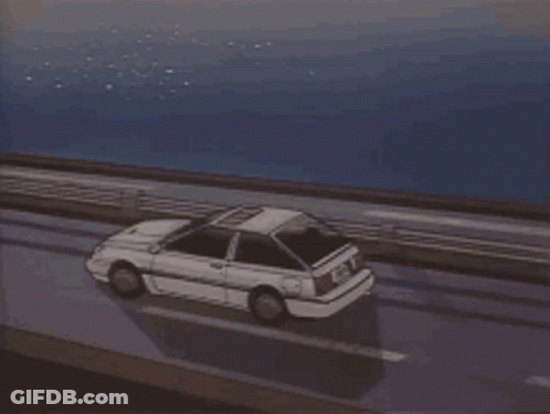 A Car Is Driving On A Highway Near The Ocean GIF