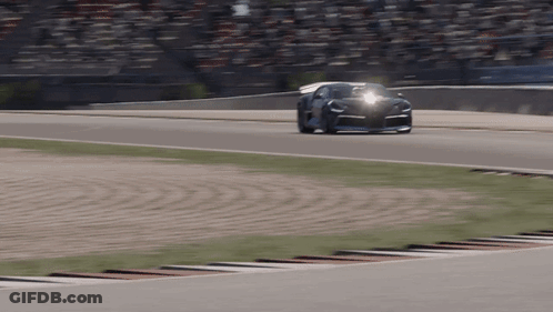 A Car Is Driving On A Race Track With A Crowd Watching GIF