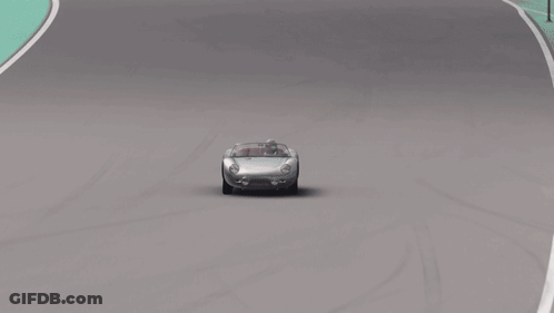 A Car Is Driving On A Race Track With A Wall That Says Project On It GIF