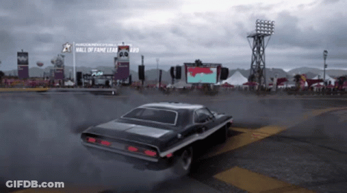 A Car Is Driving Past A Sign That Says Hall Of Fame GIF