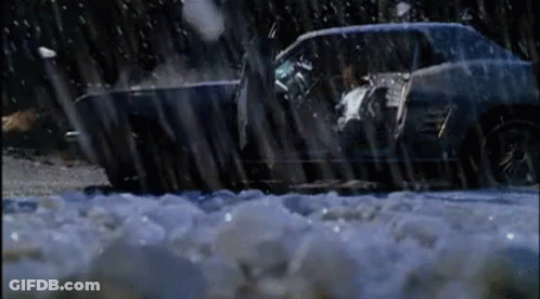 A Car Is Driving Through A Snowy Area With Ice On The Ground GIF