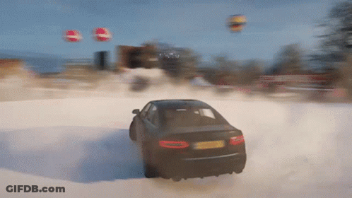 A Car Is Driving Through A Snowy Field With Balloons Flying In The Background GIF