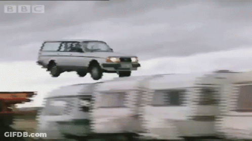 A Car Is Flying Over A Row Of Caravans With The Bbc Logo In The Corner GIF