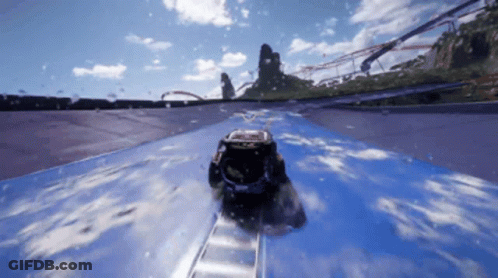A Car Is Going Down A Roller Coaster Track With A Red Bull Logo On The Side GIF
