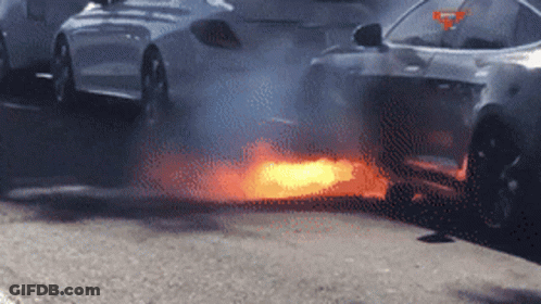 A Car Is On Fire And Smoke Is Coming Out Of The Exhaust Pipe GIF