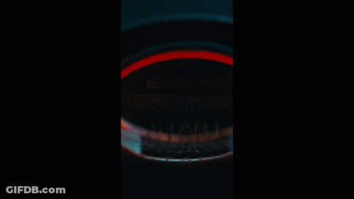 A Car Is Parked In Front Of A Building In The Dark GIF
