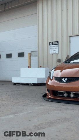 A Car Is Parked In Front Of A Building With A Sign That Says No Parking GIF