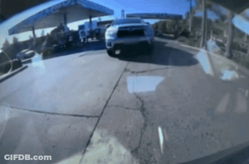 A Car Is Parked In Front Of A Gas Station With A Sign That Says ' Chevron ' On It GIF