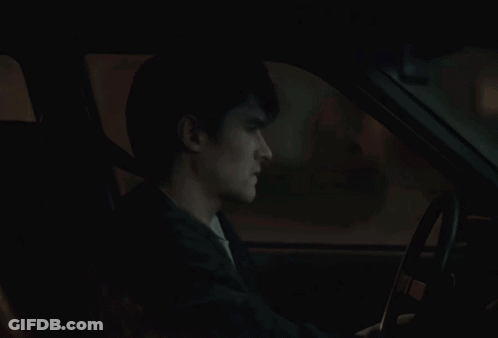 A Car Is Parked In Front Of A House With A Picture Of A Man And The Words True On It GIF