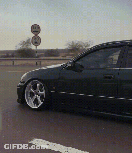 A Car Is Parked In Front Of A Sign That Says 140 And 80 GIF