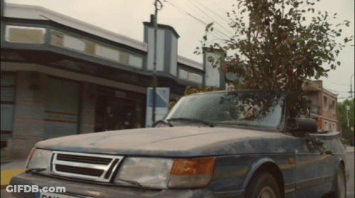 A Car Parked In Front Of A Building With A License Plate That Says ' Dal ' On It GIF