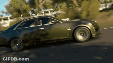 A Car With A Cross On The Side Is Driving Down The Road GIF