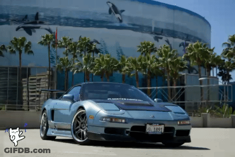 A Car With A License Plate That Says 1691 Is Parked In Front Of A Building GIF