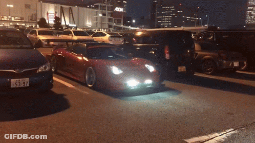 A Car With A License Plate That Says 53-97 Is Driving Down The Road GIF