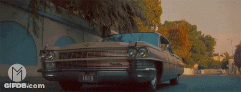 A Car With A License Plate That Says L610 Is Driving Down A Street GIF