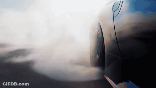 A Car With Smoke Coming Out Of Its Tire GIF