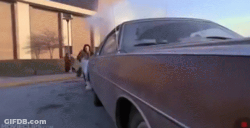 A Car With Smoke Coming Out Of The Exhaust Pipe GIF
