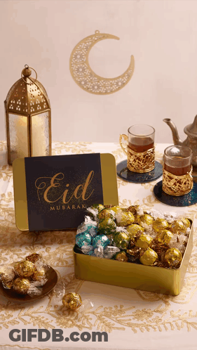 A Card That Says Eid Mubarak Sits Next To A Box Of Chocolates GIF