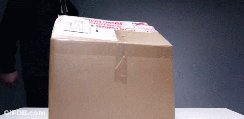 A Cardboard Box With A Sticker On It That Says ' Fragile ' GIF