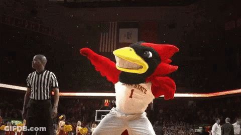 A Cardinal Mascot Is Dancing On A Basketball Court In Front Of A Referee GIF