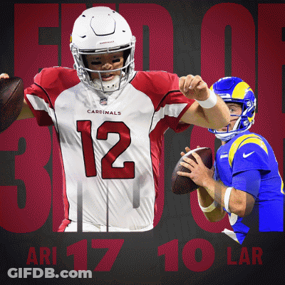 A Cardinals Player Is Holding A Football In Front Of Another Player GIF