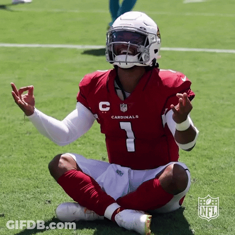 A Cardinals Player Is Sitting On The Field With His Legs Crossed GIF