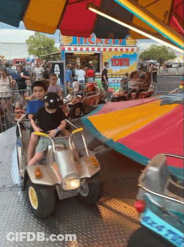 A Carnival Ride Has A Sign That Says Tickets On It GIF