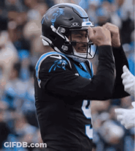 A Carolina Panthers Football Player Wearing A Black Helmet GIF