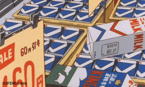 A Carton Of King Milk Sits On A Shelf Next To Other Cartons GIF