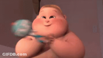 A Cartoon Baby Is Holding A Rattle And Smiling While Sitting On A Bed . GIF