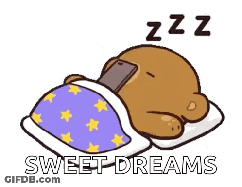 A Cartoon Bear Is Sleeping In A Bed With A Cell Phone In Its Paws . GIF