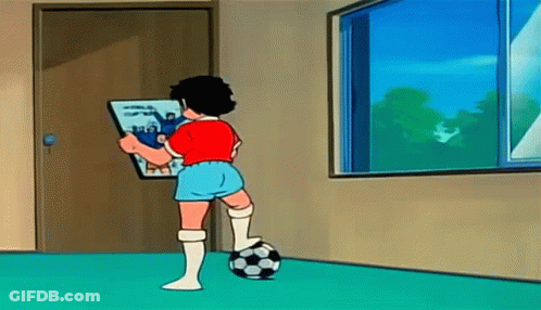 A Cartoon Boy Is Standing Next To A Soccer Ball In A Room Holding A Book . GIF