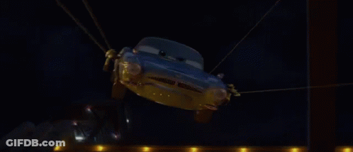 A Cartoon Car Is Flying Through The Air In Front Of A Fire GIF