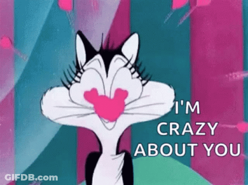 A Cartoon Cat Is Holding A Heart In Its Mouth And Says `` I 'M Crazy About You '' . GIF
