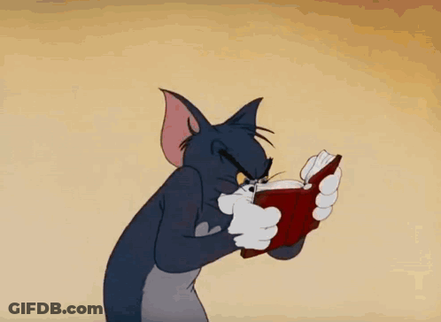 A Cartoon Cat Is Reading A Book With A Very Angry Look On His Face GIF