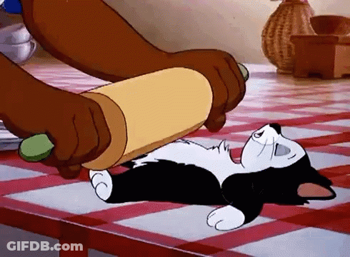 A Cartoon Cat Is Rolling Dough On A Table With A Rolling Pin . GIF