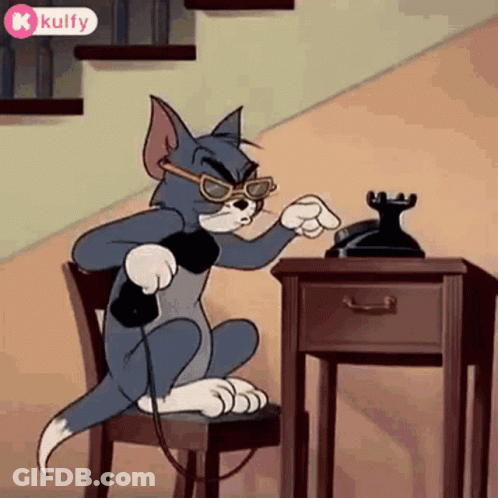 A Cartoon Cat Is Sitting In A Chair Talking On A Phone . GIF