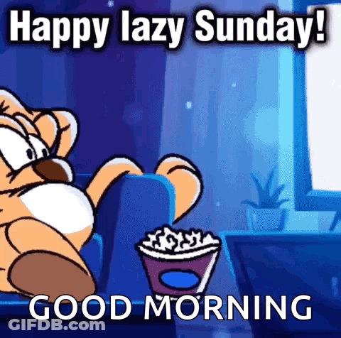 A Cartoon Cat Is Sitting On A Couch Eating Popcorn And Says Happy Lazy Sunday ! Good Morning . GIF