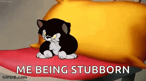 A Cartoon Cat Is Sitting On A Pillow With The Words `` Me Being Stubborn '' Written Below It . GIF