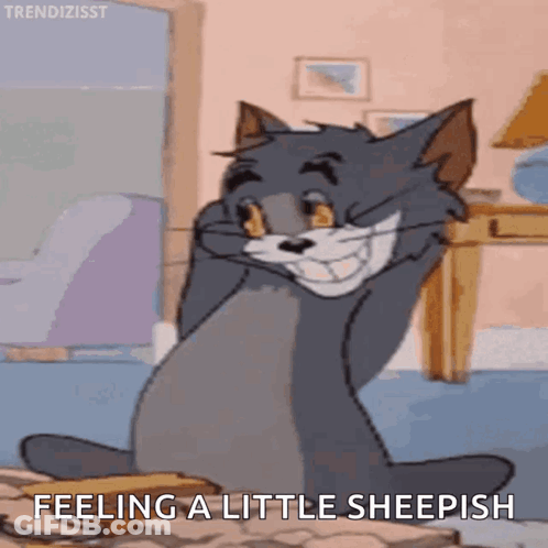 A Cartoon Cat Is Sitting On A Table With The Words Feeling A Little Sheepish Below It GIF