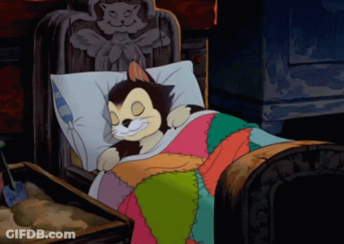 A Cartoon Cat Is Smiling While Sleeping In A Bed GIF