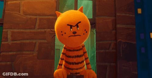 A Cartoon Cat Is Standing In Front Of A Brick Wall With An Angry Face GIF