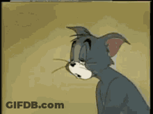A Cartoon Cat Named Tom Is Sitting On A Couch GIF