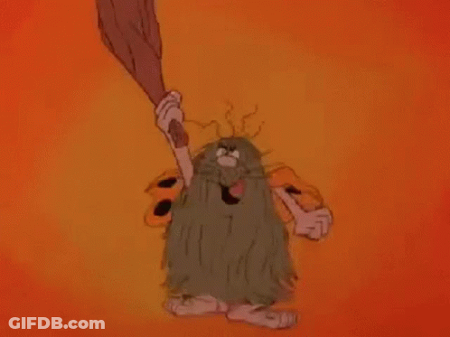 A Cartoon Caveman With A Beard Is Holding A Bat In His Hand . GIF