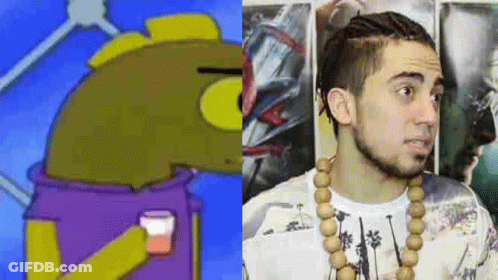 A Cartoon Character And A Man With A Beard Are Standing Next To Each Other . GIF