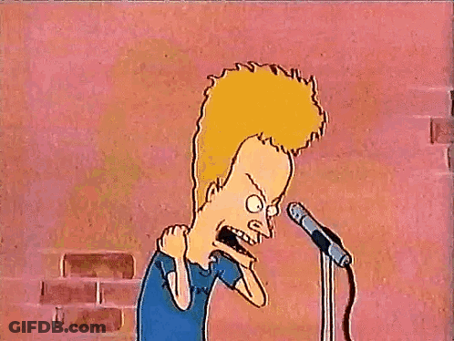 A Cartoon Character From Beavis And Butthead Is Standing In Front Of A Microphone With His Arms In The Air . GIF