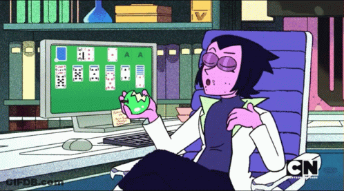 A Cartoon Character From Cn Sits In Front Of A Computer Screen Playing Solitaire GIF