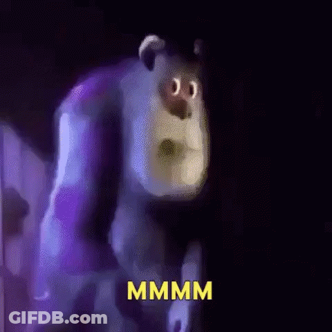 A Cartoon Character From Monsters Inc Is Standing In A Dark Room With The Word Mmmm Written On The Bottom . GIF